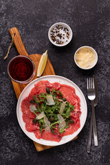 Marbled beef carpaccio with arugula, capers and parmesan cheese