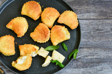 Fresh baked home made  Mini cheese puff pastries.Cheese pie with phyllo pastry and herbs