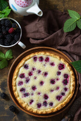 Homemade blackberry pie. Sweet pie with blackberry on rustic wooden table. Top view flat lay background.