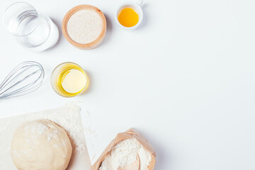 Homemade yeast dough next to whole grain flour