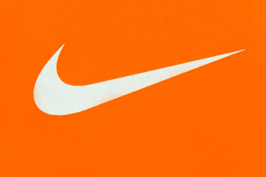 White Nike Logo on Orange Background