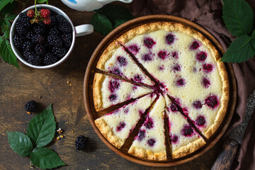 Homemade blackberry pie. Sweet pie with blackberry on rustic wooden table. Top view flat lay background.