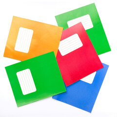Colorful school exercise books on white background.
