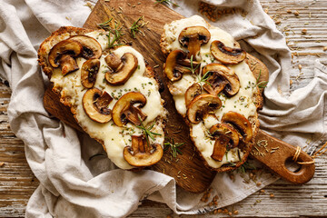 Toasted sandwich from traditional sourdough bread with cheese and brown mushrooms seasoned with...