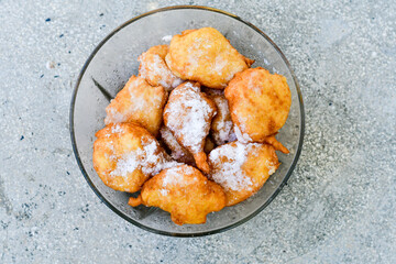 Traditional Bulgarian home made deep fried  patties  covered with sugar  оn rustic backgroud.Mekitsa or Mekica,  on wooden  rustic  background. Made of kneaded dough that is deep fried 