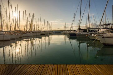 Fototapeta na wymiar Marina with walkway and boats at sunset