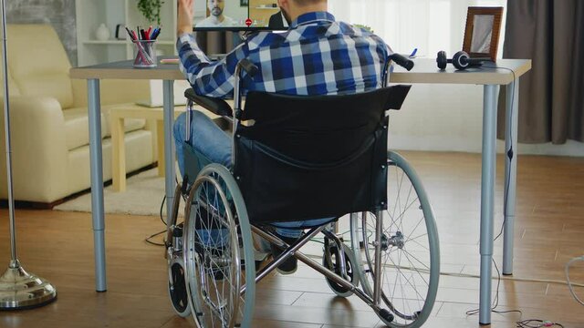 Freelancer with walking disability in wheelchair during online business video call. Handicapped invalid paralysed freelancer, immobilized entrepreneur working from home, ilness and disability