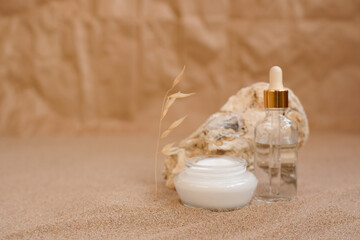 Caring cosmetics in an oyster shell on the sand. Eco-friendly organic cosmetics.