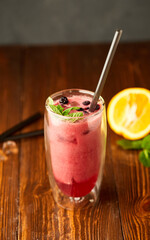 Tasty blackberry smoothie with mint and fresh berries in glasses on wooden background