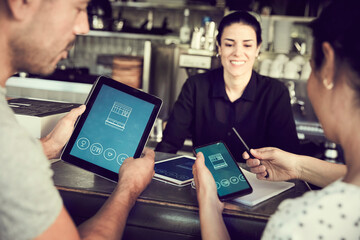 Smiling man using smart phone while women looking in cafe