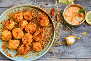  Home made Crispy Popcorn Chicken  with honey mustard sauce on wooden background