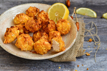  Home made Crispy Popcorn Chicken  with honey mustard sauce on wooden background