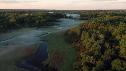 Obraz premium Aerial view of american countryside in the summertime. Sunrise, dawn, misty early morning. North american rural landscape, Beautiful nature of Midwest
