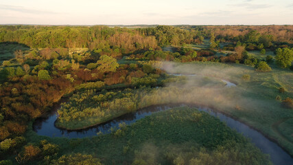 Aerial view of american countryside in the summertime. Sunrise, dawn, misty early morning. North american rural landscape,  Beautiful nature of Midwest