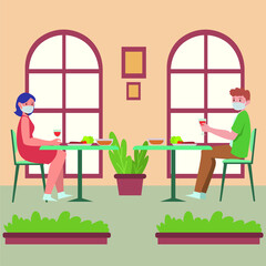 Woman and man are having dinner together in restaurant with seperate table because of pandemic