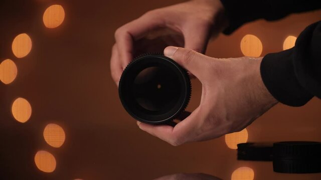 Hand model opens and closes aperture on a cine lens.