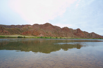 Sunset in the steppe in a river valley. Beautiful sunset. Landscape in the steppe, Prairie. Landscape in the evening. The clouds.