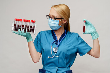medical doctor nurse woman wearing protective mask and gloves - holding rack with virus blood tests
