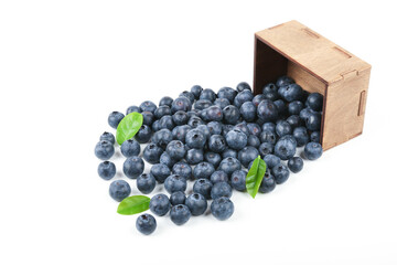 blueberry berries with green leaves in wooden box isolated on white background