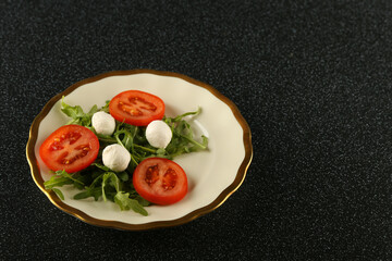 salad of tomatoes, herbs and mozzarella on a plate