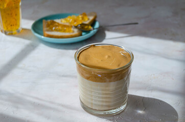 delicious Breakfast, coffee and slices of loaf with jam on a light background