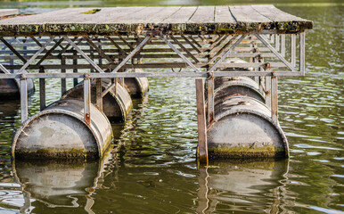 Fototapeta na wymiar Improvised pontoon port on barrels on the Danube 