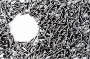 Lots of metal screws. White background. Copy space