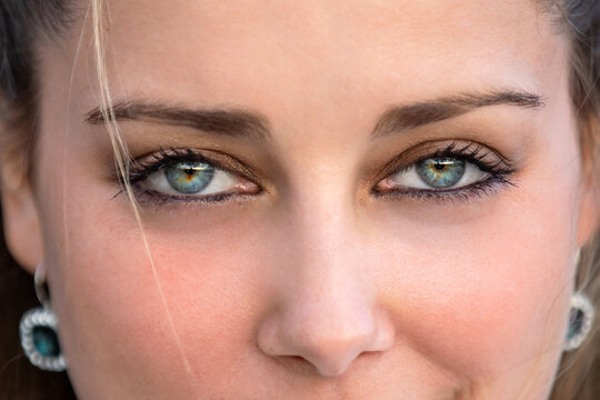 Close up female portrait on intense piercing blue eyes, confident, flirtatious, seductive, sensual stare