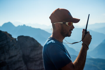 portrait of young man communicating on a two way radio.
man doing a communications test before...