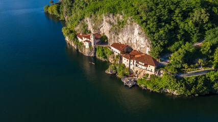 Aerial view of the hermitage of Santa Caterina del Sasso Ballaro. The rock structure is a monastery built overhanging the eastern shore of Lake Maggiore, near Varese, Italy.