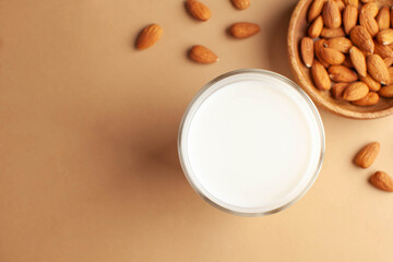 Organic almond milk, almonds on a brown background. Alternative to dairy products, milk for vegetarians. Copy space.