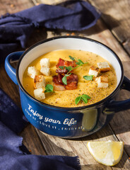 Mashed pumpkin soup, holidays, summer, autumn, vegetarian, healthy, proper nutrition, farm concept. Free space for text. Orange smoothie soup with croutons in a tureen.