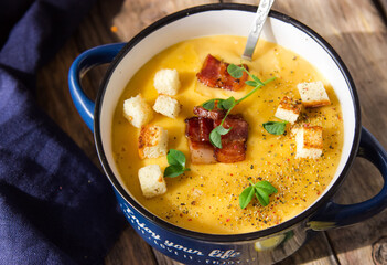 Mashed pumpkin soup, holidays, summer, autumn, vegetarian, healthy, proper nutrition, farm concept. Free space for text. Orange smoothie soup with croutons in a tureen.
