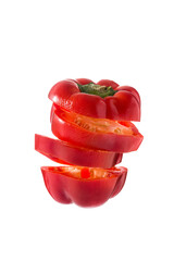 Sliced fresh red pepper cut floating in the air isolated on white background
