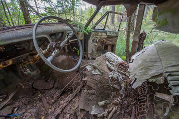 Old cars in Sscrapyard in forest in Ryd Sweden