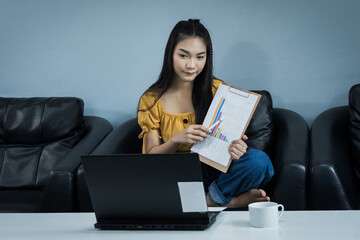 A young female university student presents her study through oline internet at home. A teenager woman spends time during covid-19 pandemic study online at home. Online and distance education concept.