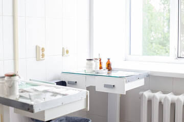 treatment room in the hospital, glass tables with medical instruments,