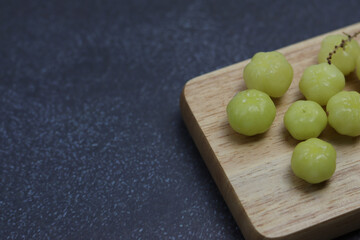 Gooseberry on a wooden side on a black background