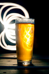 Close up Beer Glass with Light painting background. Amazing abstract colored lights in motion. Magical light in a glass of craft beer.