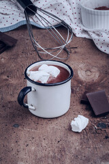 Hot chocolat with marshmallows on a rustic wooden table