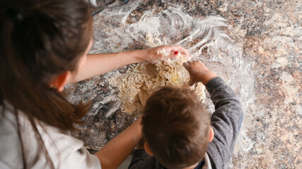 mother with baby make dough, top view