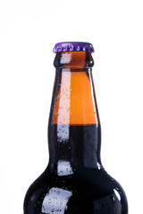 Brown beer bottles over white background. Beer with colored caps. Close up view of drinks with copy...