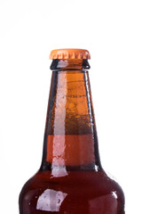 Brown beer bottles over white background. Beer with colored caps. Close up view of drinks with copy space.