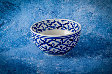 ceramic bowl on blue background.