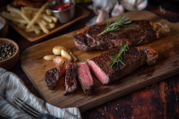 strip steak with french fries and onion rings