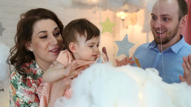 Family, parenthood and people concept - happy mother, father with baby at home