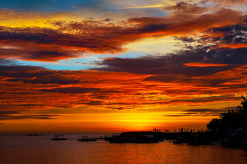 Sunset before an typhoon makes the sky explode with colors at Malandog beach on Panay island, Philippines