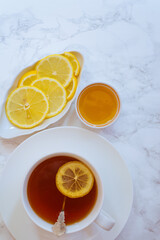 simple image of a cup of black tea with a slice of lemon,   on white background
