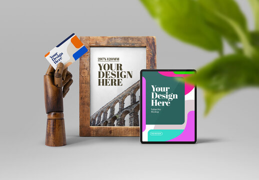 Business Card, Frame, and Tablet with Wooden Hand Mockup