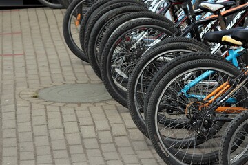 
Wheels of parked bicycles for rent